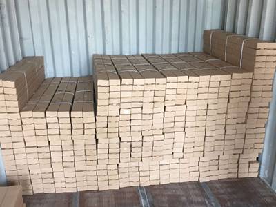 Several cartons of aluminum insect mesh in the container.