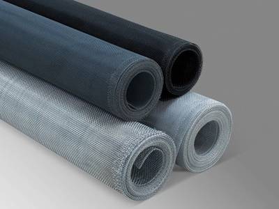 Four rolls of aluminum window screen in different colors.