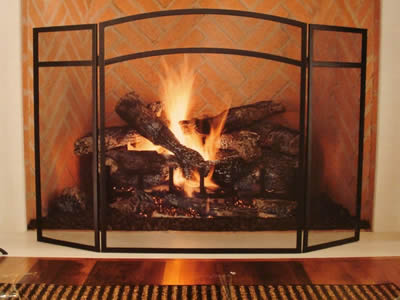 Copper wire screens are installed around the fireplace.