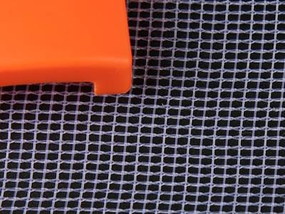 A orange object on the warp knitting white color plastic insect screen.