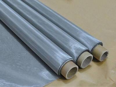 Three rolls of stainless steel printing mesh on the waterproof paper.