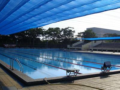 Blue color sunshade net is above the swimming pool.