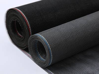 A roll of black and a roll of gray vinyl coated fiberglass insect screens on the gray background.