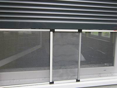 The window is covered with white vinyl coated fiberglass insect screen.